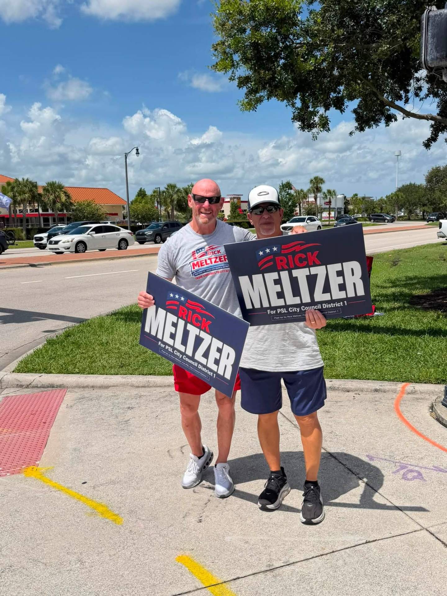 Rick Meltzer with a volunteer holding campaign signs