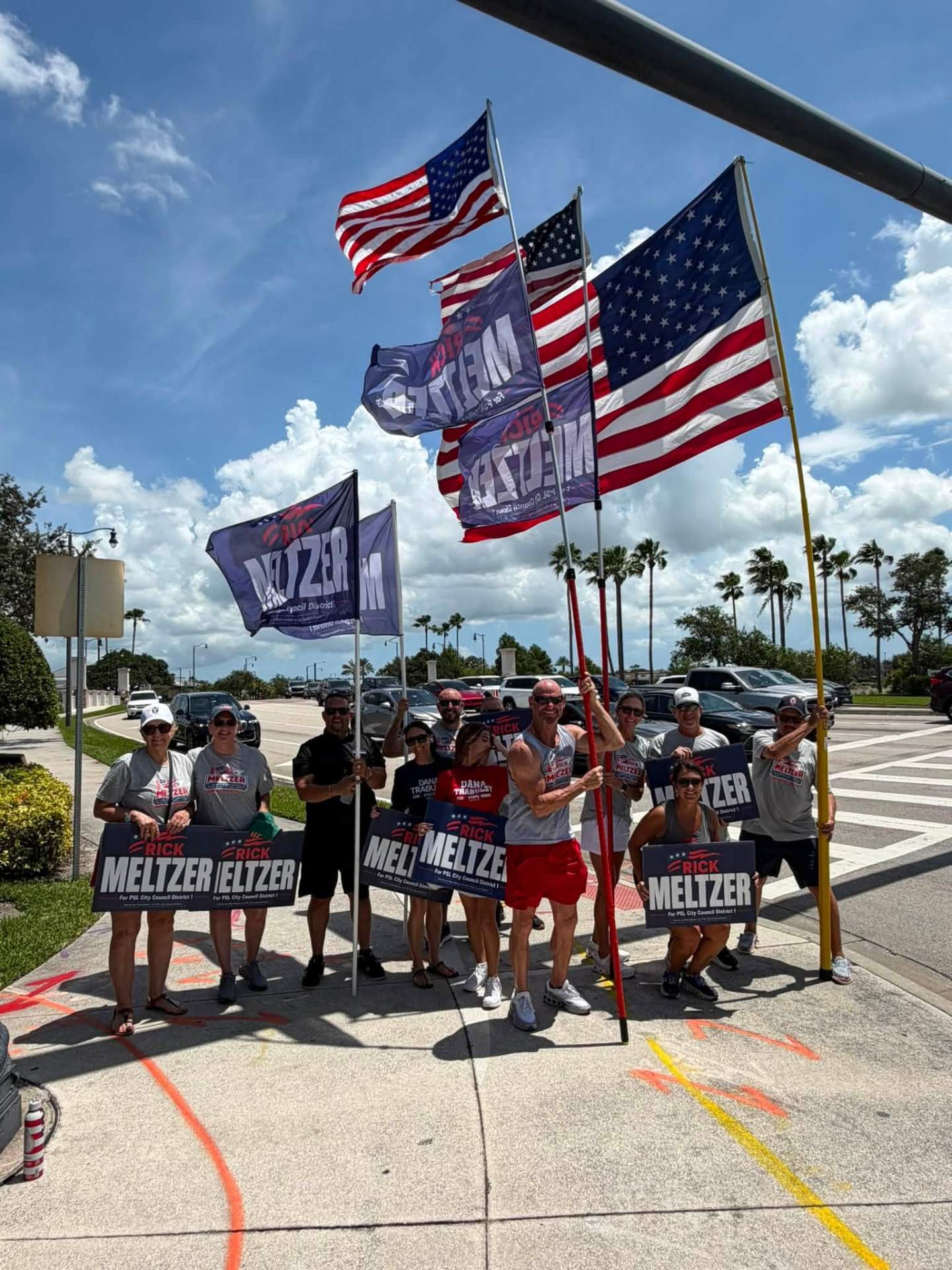 Meltzer campaign team waving signs and flags on the corner